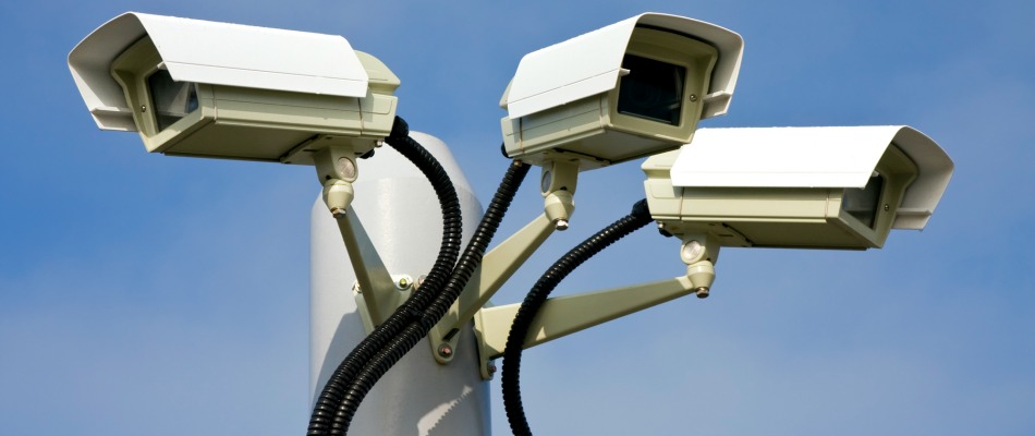 Security cctv cameras in front of blue sky